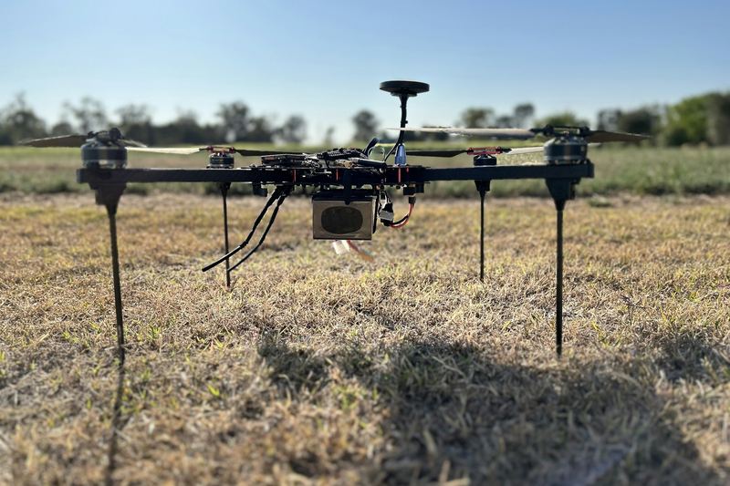 Agricultural spray drone standing on a dry paddock ready for take off
